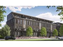 Modern brick townhome with balconies, large windows, and manicured lawn at 919 Hughley Circle # 72, Atlanta, GA 30316