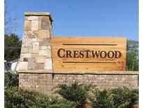 Attractive Crestwood community entrance sign featuring stone pillar, brick base, and manicured shrubbery at 1058 Crest Mill Dr, Marietta, GA 30008