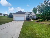 Charming single-story home with a well-manicured lawn, two-car garage, and inviting front entrance at 4335 Northwind Dr, Ellenwood, GA 30294