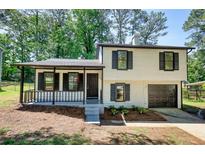 Charming two-story home with a covered front porch and a built-in garage at 3959 Wood Path Dr, Stone Mountain, GA 30083