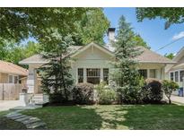 Charming single-story home with a well-manicured lawn and beautiful landscaping in a desirable neighborhood at 614 Cooledge Ne Ave, Atlanta, GA 30306