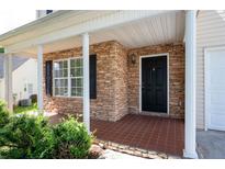 Inviting front porch featuring stone accents, neutral-colored columns, and a tile floor at 45 Waterloo Ct, Hiram, GA 30141