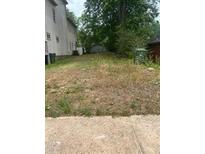 Photo shows a grassy lot ready for building in a neighborhood with mature trees at 1016 Sw Ira Sw St, Atlanta, GA 30310