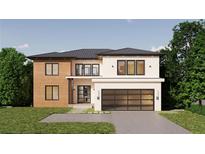 Modern two-story home featuring a contemporary design, a large garage, and a meticulously landscaped front yard at 4109 Abbotts Bridge Rd, Duluth, GA 30097