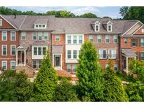 Inviting brick townhomes showcasing classic architectural details and lush landscaping for enhanced curb appeal at 3585 Adelaide Xing, Brookhaven, GA 30319