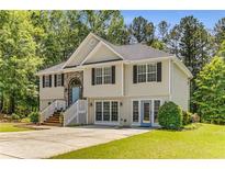 Charming two-story home featuring a welcoming entryway, neutral siding, and a well-maintained front yard surrounded by mature trees at 3835 Annandale Ln, Suwanee, GA 30024