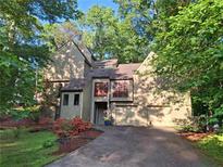Beautiful two-story home with a well-manicured lawn, mature trees, and a two-car garage at 2505 Oakrill Rd, Marietta, GA 30062