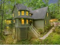 Charming two-story home with a unique turret and welcoming front porch surrounded by lush greenery at 284 Due West Ct, Dallas, GA 30157