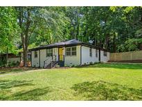 Charming, renovated single-story home with a freshly painted exterior and manicured front yard at 1678 Capistrana Pl, Decatur, GA 30032