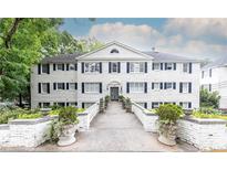 Charming white-painted three-story building with symmetrical window and shutter design at 35 Sheridan Ne Dr # 7, Atlanta, GA 30305