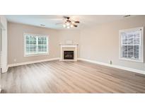 Bright living room features a fireplace, ceiling fan, and hardwood floors at 300 Oregan Trl, Marietta, GA 30080
