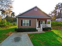 Charming single-story home with a well-maintained lawn and inviting front porch at 207 Brownlee Sw Rd, Atlanta, GA 30331