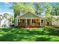 Charming home with a covered front porch and a lush green lawn at 1321 Avon Sw Ave, Atlanta, GA 30310