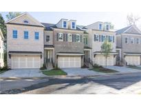 Charming townhomes feature multi-car garages and eye-catching architectural details at 2260 Siskin Square Rd # 90, Duluth, GA 30096