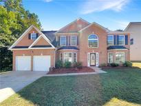 Charming two-story brick home with a well-manicured lawn and a two-car garage at 6260 Selborn Sw Dr, Atlanta, GA 30331