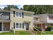 Charming two-story townhome with light green siding, black shutters, and well-maintained front lawn at 6964 Oakhill Cir, Austell, GA 30168
