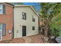 Charming townhome with a mix of brick and siding facade and a well-manicured front yard at 7004 Pat Mell Se Pl, Smyrna, GA 30080