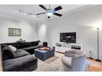 Bright living room featuring a plush sectional sofa, stylish decor, and a modern ceiling fan for added comfort at 400 17Th Nw St # 1119, Atlanta, GA 30363