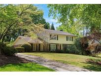 Charming two-story home featuring a well-manicured lawn and a long driveway at 4261 Brookview Se Dr, Atlanta, GA 30339