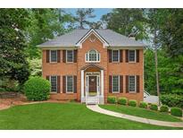 Charming brick two-story home featuring a well-manicured lawn and inviting front entrance at 2622 Murdock Rd, Marietta, GA 30062