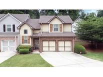 Charming home with a well-manicured lawn, a two-car garage, and beautiful exterior detailing at 989 Brownstone Ln # 16, Marietta, GA 30008