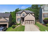 Charming two-story home with a well-manicured lawn, a two-car garage, and attractive landscaping at 456 Crestmont Ln, Canton, GA 30114