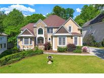 Stunning two-story home featuring a stone facade and manicured front lawn at 5309 Ashley Trce, Atlanta, GA 30360