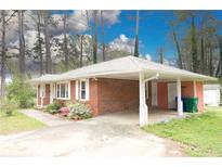 Charming single-story brick home with a convenient carport and well-maintained landscaping at 1693 Montreal Rd, Tucker, GA 30084