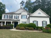 Charming two-story home with a well-manicured front yard and classic white facade at 970 Tarpley Nw Rd, Kennesaw, GA 30152