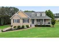 Charming single-Gathering home featuring a well-manicured lawn, lovely landscaping, and a welcoming front porch at 137 Cambridge Pointe, Villa Rica, GA 30180