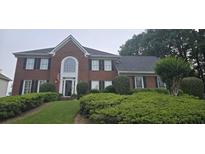 Charming brick home featuring a well-manicured lawn and welcoming front entrance at 530 Veranda Ct, Alpharetta, GA 30009