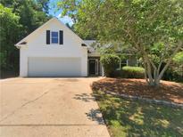Charming one-story home featuring a well-manicured lawn and attached two-car garage at 575 Freeman Dr, Covington, GA 30016