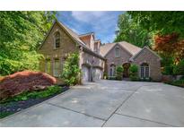 Charming brick home boasts a two-car garage, mature landscaping, and a beautifully paved driveway at 1255 Beech Haven Ne Rd, Atlanta, GA 30324