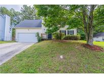 Charming two-story home with a well-manicured front yard and attached two-car garage at 3075 Oakvale Hts, Decatur, GA 30034