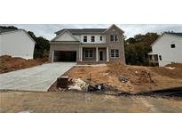 New two-story brick home featuring a two-car garage and a classic, welcoming front porch design at 314 Level Creek Rd, Sugar Hill, GA 30518