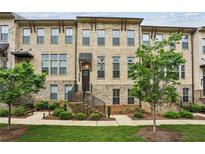 Charming brick townhouse with well-manicured lawn and landscaped front yard at 631 Avondale Creek Dr, Decatur, GA 30032