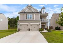 Charming two-story home featuring a two-car garage and a covered balcony at 1048 Shadow Glen Dr, Fairburn, GA 30213