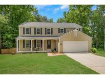 Charming two-story home boasts a well-manicured lawn and a welcoming front porch at 1380 Heritage Glen Dr, Marietta, GA 30068