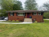 Charming brick home featuring a well-manicured lawn, new sidewalk, and a neatly landscaped front yard at 3731 Wisteria Se Ln, Smyrna, GA 30082