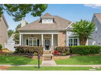Charming home with stone accents, manicured landscaping, and a welcoming front porch perfect for relaxing at 753 Cambron Commons Trce, Suwanee, GA 30024