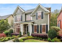 Charming two-story home with manicured lawn, stone accents, and inviting architectural details at 963 Manor Parc Dr, Decatur, GA 30033