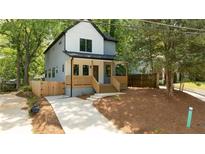 Charming two-story home with modern farmhouse style and a well-manicured front yard and inviting front porch at 140 Racine Sw St, Atlanta, GA 30314