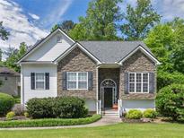 Charming home featuring stone accents, manicured lawn, and a welcoming front entrance at 100 Sydney Smt, Villa Rica, GA 30180