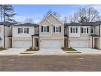 Modern townhome exterior with a two-car garage, neutral color palette, and professionally landscaped front yard at 520 Amethyst Way, Stockbridge, GA 30281