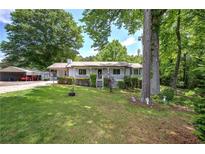 Charming single-story home featuring a cozy front porch and a well-maintained lawn with mature trees at 1095 Dallas Nebo Rd, Dallas, GA 30157