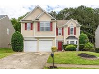Charming two-story home featuring a two-car garage, red shutters, and a well-manicured lawn at 3514 Ethridge Nw Ln, Kennesaw, GA 30144
