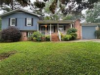Charming two-story home with brick accents and a well-maintained front lawn at 4718 City View Dr, Forest Park, GA 30297
