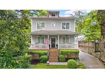 Charming two-story home with landscaped front yard and inviting front porch, perfect for relaxing at 66 Mobile Ne Ave, Atlanta, GA 30305