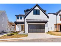 Modern two-story home featuring painted brick, black trim, and a front-entry two car garage at 1240 Hayes Sq, Peachtree City, GA 30269