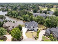 Stunning aerial view of waterfront property with lush landscaping, golf course in background at 2837 Darlington Run, Duluth, GA 30097